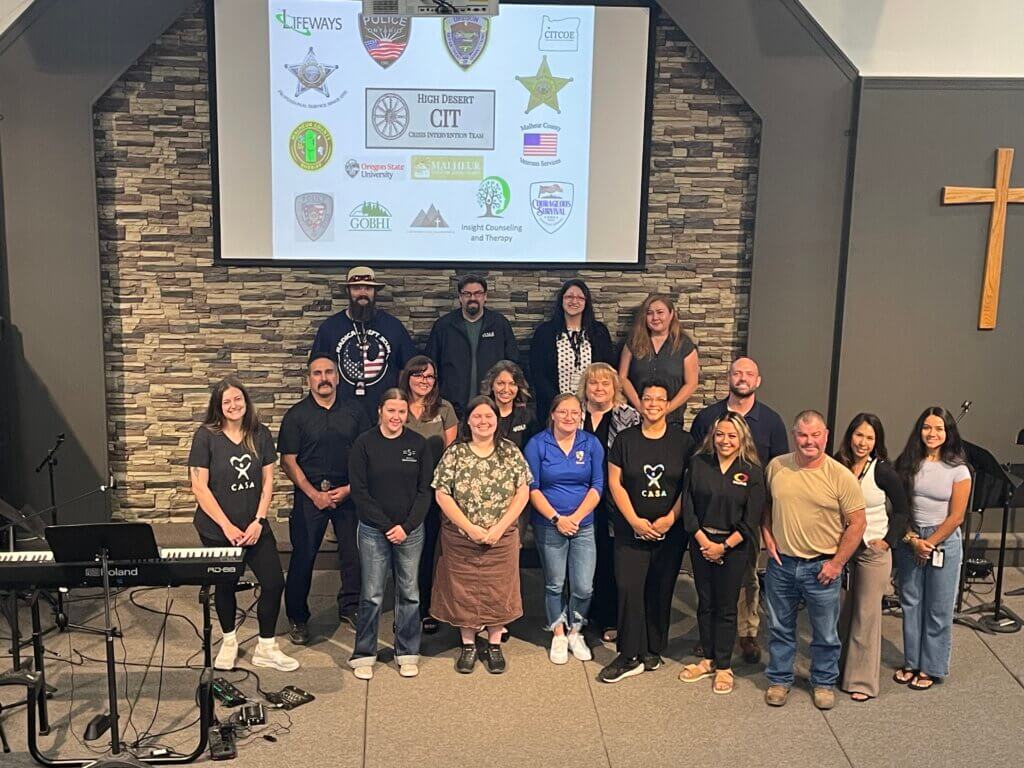 18 adult individuals who participated in the CIT training standing in front of the CIT presentation